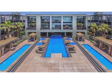Beautiful resort-style pool area with cabanas and lounge chairs for relaxing and enjoying the sun at 8925 W Flamingo Rd # 310, Las Vegas, NV 89147