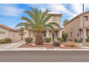 Charming two-story home with a well-manicured front yard and a mature palm tree at 9788 Altadena St, Las Vegas, NV 89183