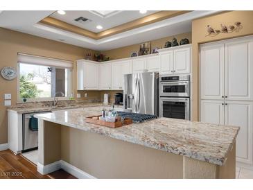 Bright kitchen features granite counters, stainless steel appliances, and ample cabinet space at 10640 Mission Lakes Ave, Las Vegas, NV 89134