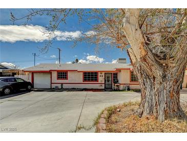 Charming single-story home featuring a spacious driveway and mature tree in the front yard at 111 Narcissus Ln, Las Vegas, NV 89107