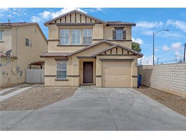 Charming two-story home featuring a well-manicured front yard, attached garage, and inviting facade at 1131 Orange Meadow St, Las Vegas, NV 89142