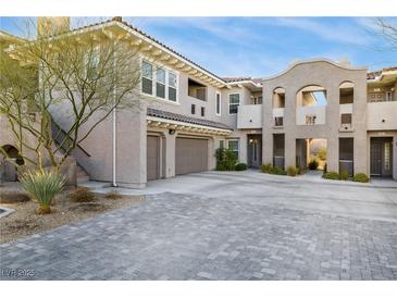 Mediterranean-style condo featuring stucco walls, arched entryways, and a two-car garage at 11890 Tevare Ln # 1098, Las Vegas, NV 89138