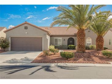 Charming single-story home featuring desert landscaping, a tile roof, and a two-car garage at 2306 Valley Cottage Ave, Henderson, NV 89052