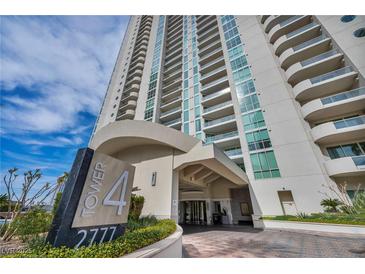 Elegant high-rise exterior showing the building facade and entrance, accented by manicured landscaping and blue sky at 2777 Paradise Rd # 301, Las Vegas, NV 89109