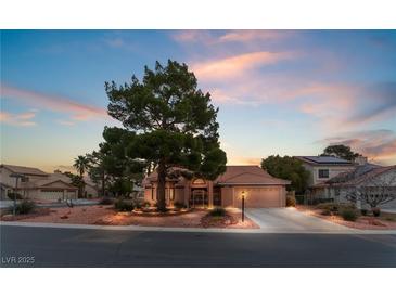 Charming single-story home with mature landscaping, a well-manicured yard, and a spacious driveway at 5528 Apache Wells Way, Las Vegas, NV 89130