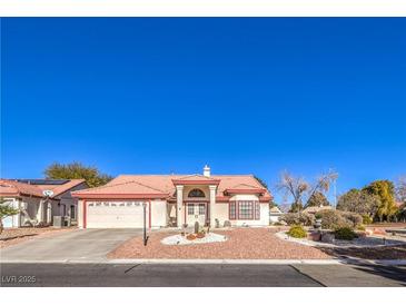 Charming single-story home featuring a well-manicured yard, desert landscaping, and a spacious two-car garage at 5604 Ocean Pines Cir, Las Vegas, NV 89130