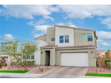 Modern two-story home features a two-car garage, desert landscaping, and tile roof at 9675 Bold Skye Ave, Las Vegas, NV 89166