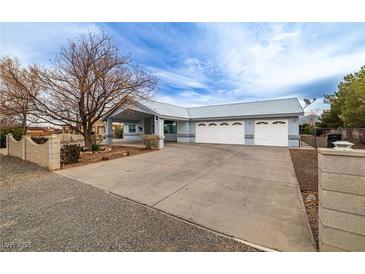 Charming single-story home showcasing a three-car garage and well-maintained front yard landscaping at 2281 Wagon Ave, Pahrump, NV 89048