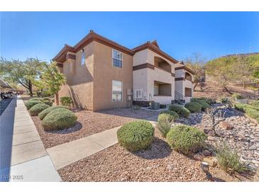 A charming condo with an earth-toned exterior, complemented by well-maintained landscaping and a clear blue sky at 231 W Horizon Ridge Pkwy # 812, Henderson, NV 89012