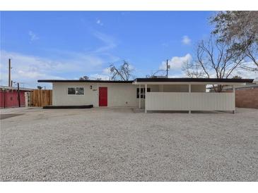 Charming single-story home with a modern design, red door, and low-maintenance landscaping at 2837 Reynolds Ave, North Las Vegas, NV 89030