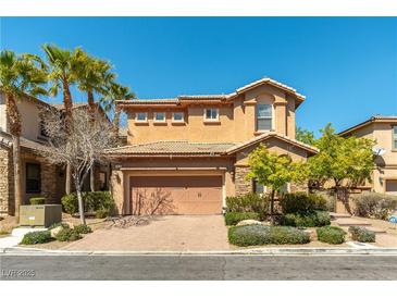 Charming two-story home with well-maintained landscaping, a brick driveway, and a two car garage at 1013 Baronet Dr, Las Vegas, NV 89138