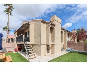 Charming condo featuring a private deck, desert landscaping, and stair access on a sunny day at 1312 Georgia Ave # D, Boulder City, NV 89005