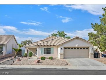Charming single-story home with well-manicured landscaping, tile roof, and an attached two car garage at 1326 Winter Solstice Ave, Henderson, NV 89014