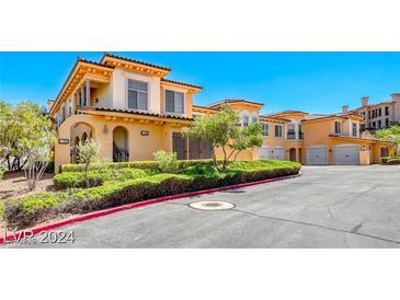 Elegant two-story home featuring a tile roof, manicured landscaping, and a private gated entrance at 21 Via Visione # 101, Henderson, NV 89011