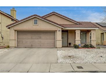 Charming single-story home featuring a two-car garage, desert landscaping, and a cozy front porch at 2308 Avery Dr, Las Vegas, NV 89108