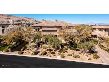 Beautiful home with lush landscaping, mature trees, and a welcoming entrance at 30 Meadowhawk Ln, Las Vegas, NV 89135