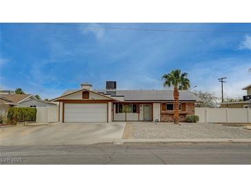 Charming single-story home featuring a two-car garage, brick accents, and well-maintained landscaping at 4678 San Benito St, Las Vegas, NV 89121