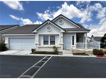 Charming single-story home featuring a two-car garage, white picket fence and landscaped front yard at 5263 Shasta Lake Way, Las Vegas, NV 89118