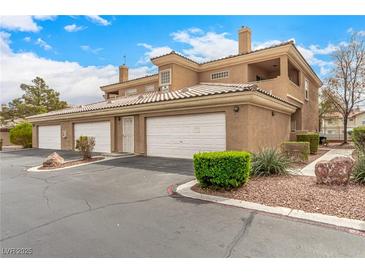 A charming multi-level condo featuring a private garage and well-maintained landscaping at 6809 Cobre Azul # 201, Las Vegas, NV 89108