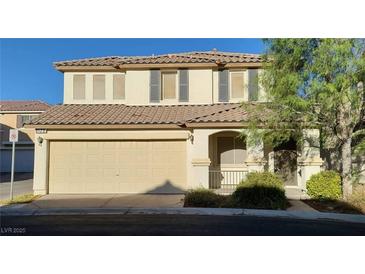 Two-story home featuring a two-car garage and well-maintained landscaping in a residential area at 8120 Finch Feather St, Las Vegas, NV 89143