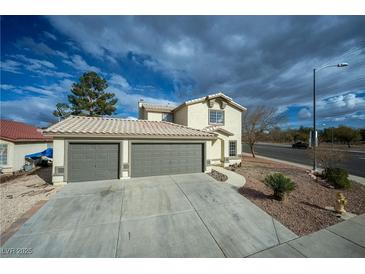 Charming home featuring a two-car garage with a spacious driveway and simple desert landscaping at 172 Cloudcrest Dr, Henderson, NV 89015