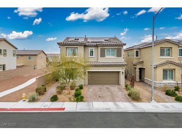 Charming home with a two-car garage, beautiful landscaping, and solar panels on the roof at 4606 Engage St, North Las Vegas, NV 89031