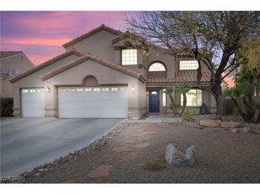 Charming two-story home featuring a three-car garage, landscaped front yard, and a welcoming entrance at 5 Rampart Ct, Henderson, NV 89074