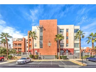 Multi-story building featuring sleek, modern architecture, palm trees, and convenient parking spaces at 51 E Agate Ave # 205, Las Vegas, NV 89123