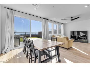 Bright dining area with table, grill on patio, and views of the city in a modern, open-concept living space at 5398 Pico Viejo St, Las Vegas, NV 89166