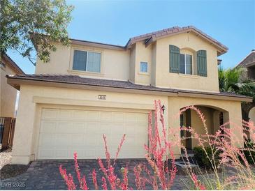 Inviting two-story home with a two-car garage, desert landscaping, and charming architectural details at 6245 Blushing Willow St, North Las Vegas, NV 89081