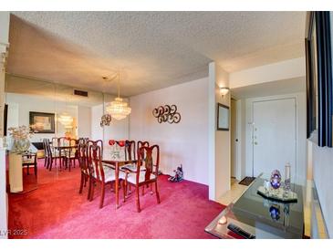 Traditional dining room featuring a chandelier, mirrored wall, and seating for six at 750 S Royal Crest Cir # 345, Las Vegas, NV 89169
