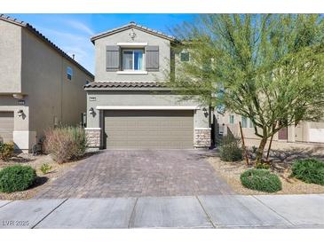 Charming two-story home boasts a well-manicured front yard, attached garage, and classic architectural details at 4735 Agave Cactus St, North Las Vegas, NV 89031