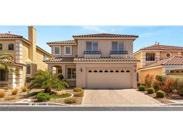 Two-story home featuring desert landscaping, a tile roof, and an attached two-car garage at 10892 Royal Highlands St, Las Vegas, NV 89141