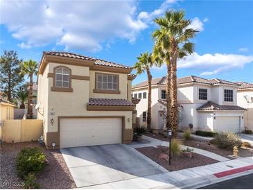 Charming two-story home with a well-manicured lawn and a spacious driveway at 1661 Warrenville St, Las Vegas, NV 89117