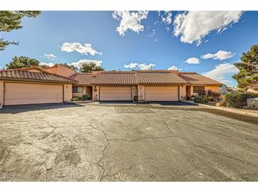 Charming townhome featuring a tile roof, two-car garage, and spacious driveway in a desirable neighborhood at 2611 Laguna Shores Ln, Las Vegas, NV 89121