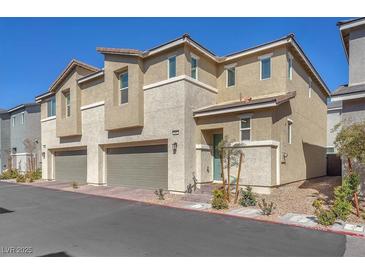 Modern two-story home featuring a two car garage, neutral color palette, and tidy landscaping at 2682 Weathered Copper Ave, North Las Vegas, NV 89086