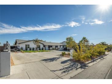 Beautifully renovated home with a modern exterior, spacious driveway, and tasteful landscaping at 2870 Belcastro St, Las Vegas, NV 89117