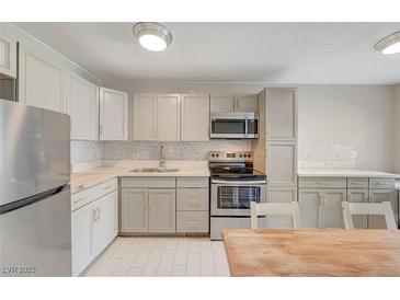 Charming kitchen featuring stainless steel appliances, stylish countertops, and ample cabinet space at 304 Orland St # 38, Las Vegas, NV 89107