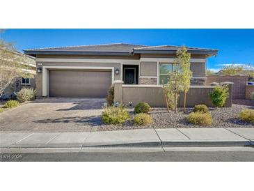 Beautiful one-story home featuring desert landscaping, a two-car garage, and a charming front entrance at 370 Mano Destra Ln, Henderson, NV 89011