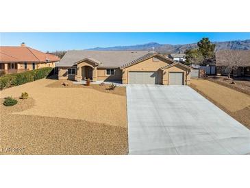 Charming single-story home with a three-car garage, xeriscaping, and mountain views at 5450 Barnwood Ct, Pahrump, NV 89061