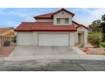 Two-story home featuring a red tile roof, a three-car garage, and low-maintenance landscaping at 9529 Shallow Brook Cir, Las Vegas, NV 89117