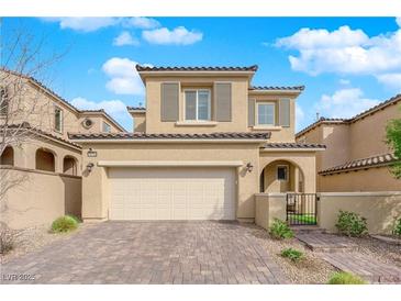 Charming two-story home featuring neutral colors, shuttered windows, tile roof and an attached two-car garage at 10792 Crestview Pointe Ave, Las Vegas, NV 89166