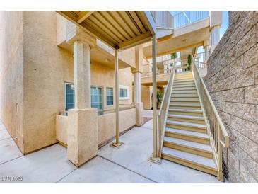 Exterior view of condo building featuring stairs and covered walkways at 1817 Cutlass Dr # 0, Henderson, NV 89014