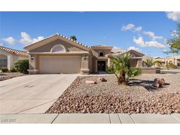Charming single-story home featuring desert landscaping, a two-car garage and a neutral color palette at 3033 Bonnie Rock Dr, Las Vegas, NV 89134