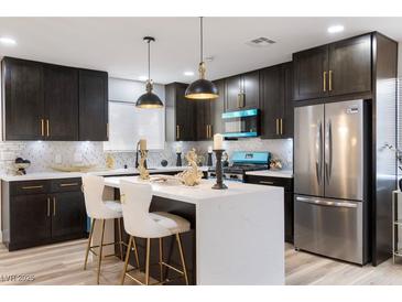Well-lit kitchen featuring stainless steel appliances, sleek countertops and stylish lighting at 3645 E Viking Rd, Las Vegas, NV 89121