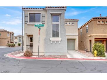 Charming two-story home with a stucco exterior and an attached garage in a residential neighborhood at 5246 Aurora Beam Ave, Las Vegas, NV 89122