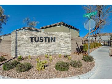 Stone entrance sign to the Tustin community, with desert landscaping and blue skies at 5691 Tinar St, Las Vegas, NV 89113