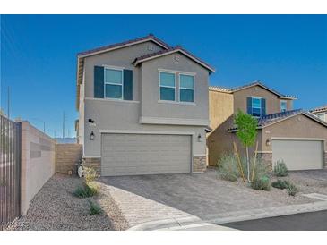 Charming two-story home showcasing a well-manicured yard, attached two car garage, and neutral color palette at 5691 Tinar St, Las Vegas, NV 89113