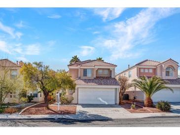 Charming two-story home featuring a tile roof and well-maintained landscaping at 8005 Dover Shores Ave, Las Vegas, NV 89128