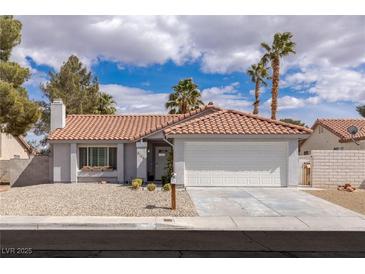 Charming single-story home with a well-manicured front yard and a two-car garage at 8198 Palmada Dr, Las Vegas, NV 89123